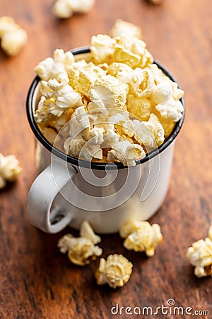 Sweet tasty popcorn in mug Stock Photo