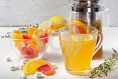 Sweet tea made from citrus fruits, berries, herbs with juicy fruit marmalades. Stock Photo