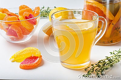 Sweet tea made from citrus fruits, berries, herbs with juicy fruit marmalades. Stock Photo