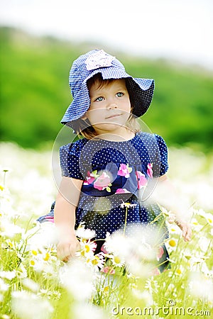 Sweet toddler in daisy field Stock Photo