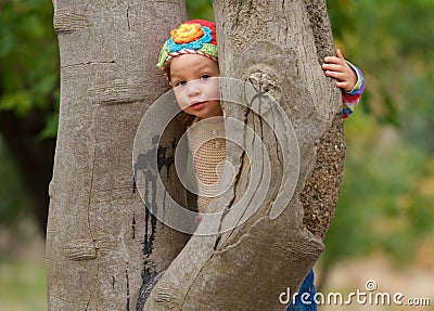 Sweet toddler girl hiding Stock Photo