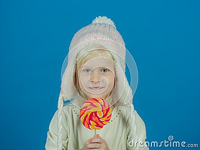 A sweet tooth. Little girl hold lollipop on stick. Little child with sweet lollipop. Happy candy girl. Happy childhood Stock Photo