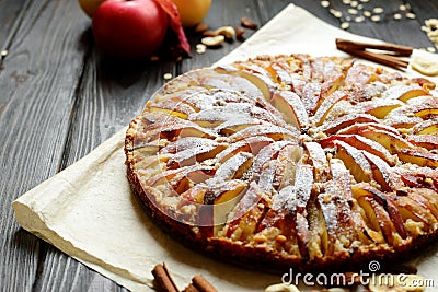 Sweet traditional homemade german apple pie cake with nuts and cinnamon on dark wooden table Stock Photo