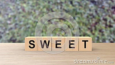 Sweet word wooden cubes on table vertical over blur background with climbing green leaves, mock up, template, Cake with cream, Stock Photo