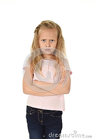 Sweet young schoolgirl with blond hair and folded arms angry upset frustrated and unhappy Stock Photo