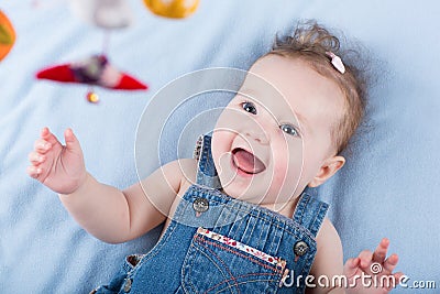 Sweetest baby girl playing with a colorful mobile toy Stock Photo