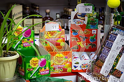 Sweets at the checkout in the store, sale of Chupa-Chups, Kinder surprises, Snickers Editorial Stock Photo
