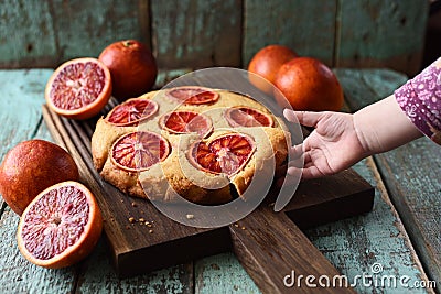 Sweets for children. Toddler hand reaching for homemade cake wit Stock Photo