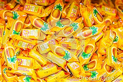 Sweets pineapple valley on store shelves, texture. Text in Russian: candy, pineapple valley, Slavyanka Editorial Stock Photo