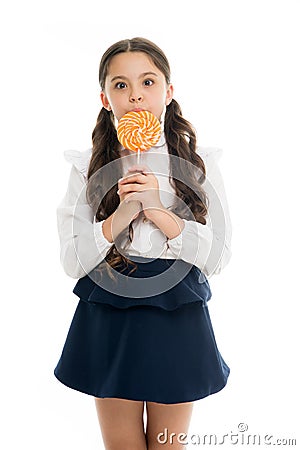 Sweets reward for study. Rewarding herself with sweets. Food addictions. Girl kid eat sweet lollipop. Girl pupil school Stock Photo