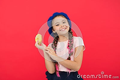 Sweets shop and bakery concept. Kids huge fans of baked donuts. Impossible to resist fresh made donut. Girl hold glazed Stock Photo