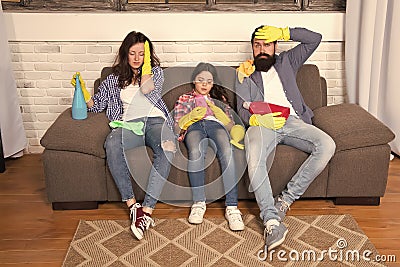 Swept away. Maid service. Best cleaning service. Family clean house. Happy family hold cleaning products. Mother, father Stock Photo