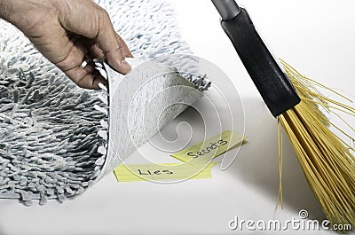 Swept under the rug Stock Photo