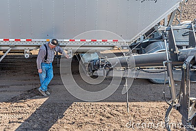 Swift Current, SK/Canada- May 15, 2020: Farmer loading fertilizer from the Super-B into Bourgault auger for seeding in Saskat Editorial Stock Photo