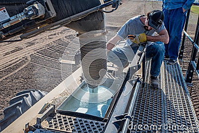 Swift Current, SK/Canada- May 15, 2020: Young farmer loading fertilizer into Bourgault air drill for seeding in Saskatchewan, Editorial Stock Photo
