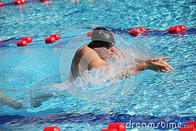 Swimmer in cap breathing performing the breaststroke Stock Photo