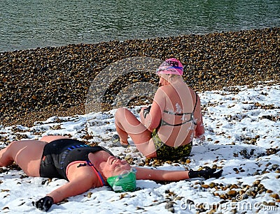 Swimmers on the beach in the snow Editorial Stock Photo