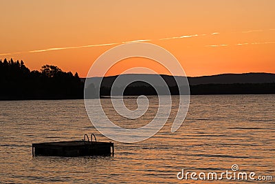 Swimming float and lake in Vermont at sunset Stock Photo