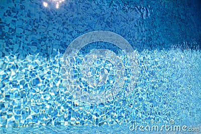 Swimming pool bottom caustics ripple and flow with waves background. Surface of blue swimming pool, background of water. Stock Photo