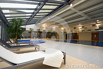 Swimming pool and chaise-longue with towel Stock Photo