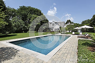 Swimming pool with deck chairs Stock Photo