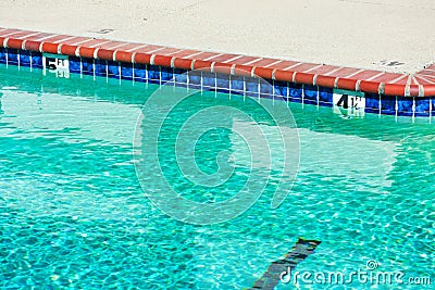 Swimming pool depth markers identify the water depth for swimmers. Four and one half feet, and five feet depth signs Stock Photo