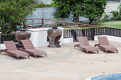 Swimming pool and empty resting chair Stock Photo