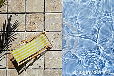 Swimming pool and empty resting chair with shadow. Top view. Stock Photo