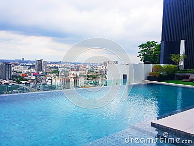 The swimming pool is in a high rise condo and overlooks the city, bangkok thailand Stock Photo