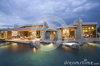 Swimming Pool And Illuminated Modern House Stock Photo