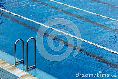 Swimming pool ladder and lane ropes Stock Photo