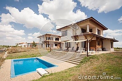 Swimming pool outside luxury home. Suburban houses. Perfect neighborhood Stock Photo