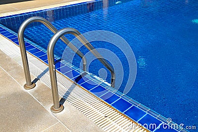 Swimming pool with sunny reflections on good weather day. Relax time with family on swimming pool. Popular sport Stock Photo