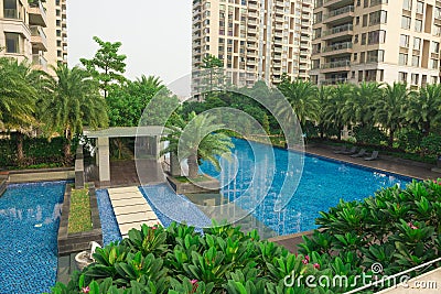 Swimming pool surrounded by residential buildings Stock Photo