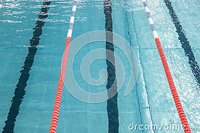 Swimming pool for swimming competitions. Empty Paths of a competitive swimming pool. Active swimming lessons. Stock Photo
