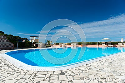 Swimming pool with tiled border and turquois water Stock Photo