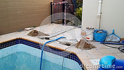 Swimming pool under repair with danger tape Stock Photo