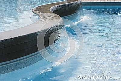 Swimming pool waterfall Stock Photo