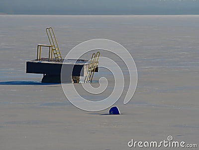Swimming resort lake with ice in winter sunny day. Abandoned pool Stock Photo