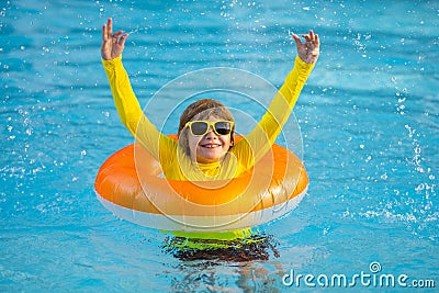 Swimming, summer vacation. Cute child playing in blue water. Kid enjoying summer vacation in water in the swimming pool Stock Photo