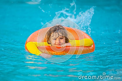 Swimming, summer vacation. Cute child playing in blue water. Kid enjoying summer vacation in water in the swimming pool Stock Photo