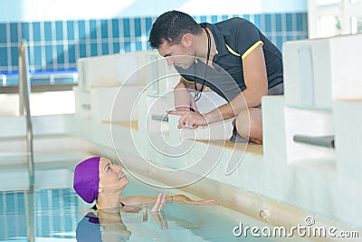 Swimming trainer giving advice to athlete Stock Photo