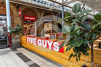 Swindon, UK - October 27, 2023: FIVE GUYS, famous franchise of fast food restaurants, burgers, fries, milkshakes in Editorial Stock Photo