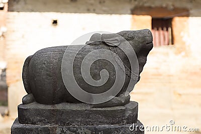 Swine stone statue seen in profile against soft pink background in Kathmandu Stock Photo