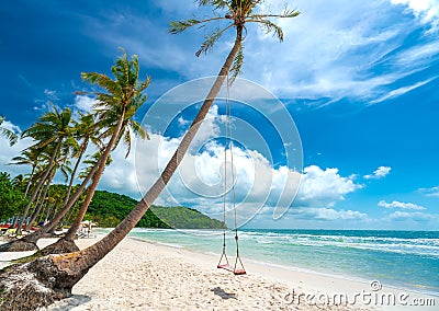 Swing attached to a palm tree in the idyllic Sao beach in Phu Quoc island Stock Photo