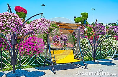 The swing bench among petunias, Miracle Garden, Dubai, UAE Editorial Stock Photo