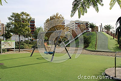 Swing and carousel on grass Editorial Stock Photo