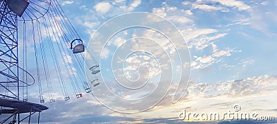 Swing chain carousel in amusement park against sky clouds background Stock Photo