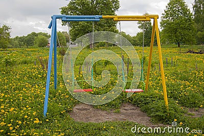 Swing for children, empty, against a background Stock Photo