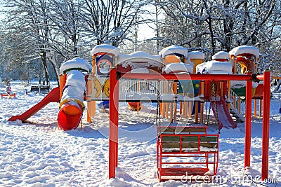Swing and playground covered with snow Stock Photo